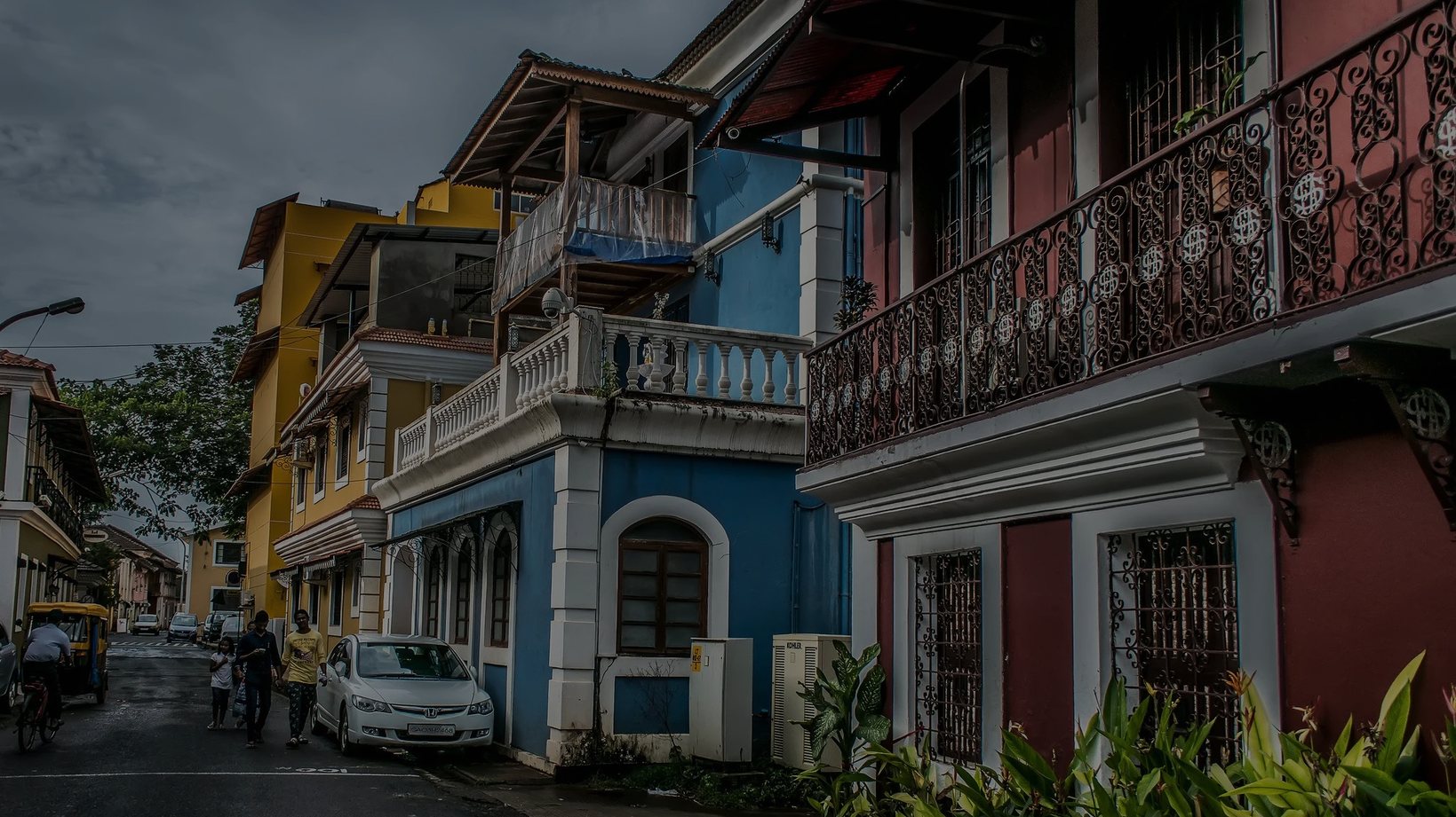Colourful Portuguese-style houses with balconies on a street in Goa